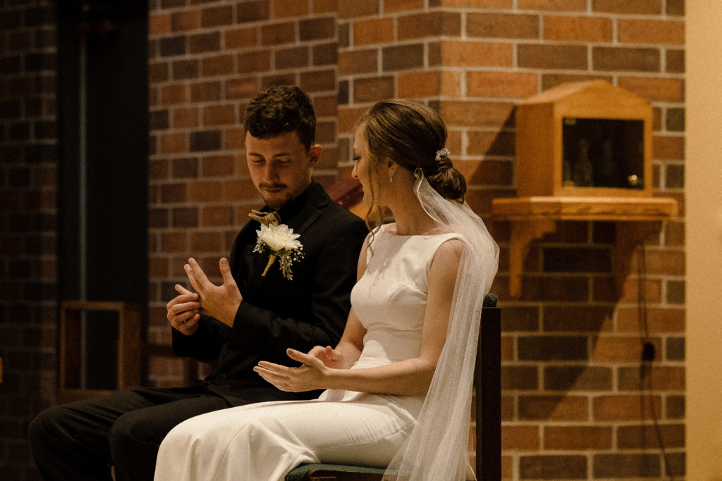 Bride and Groom seated during Catholic wedding in Watertown SD