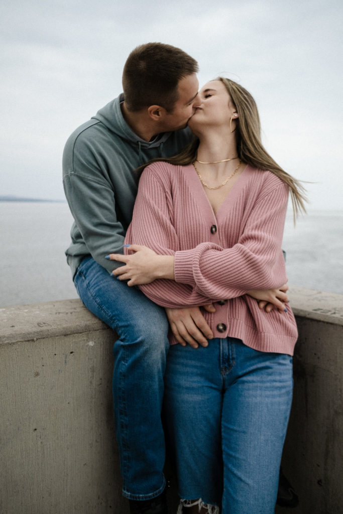 Couple kissing at the ledge of the lighthouse in Canal Park in Duluth