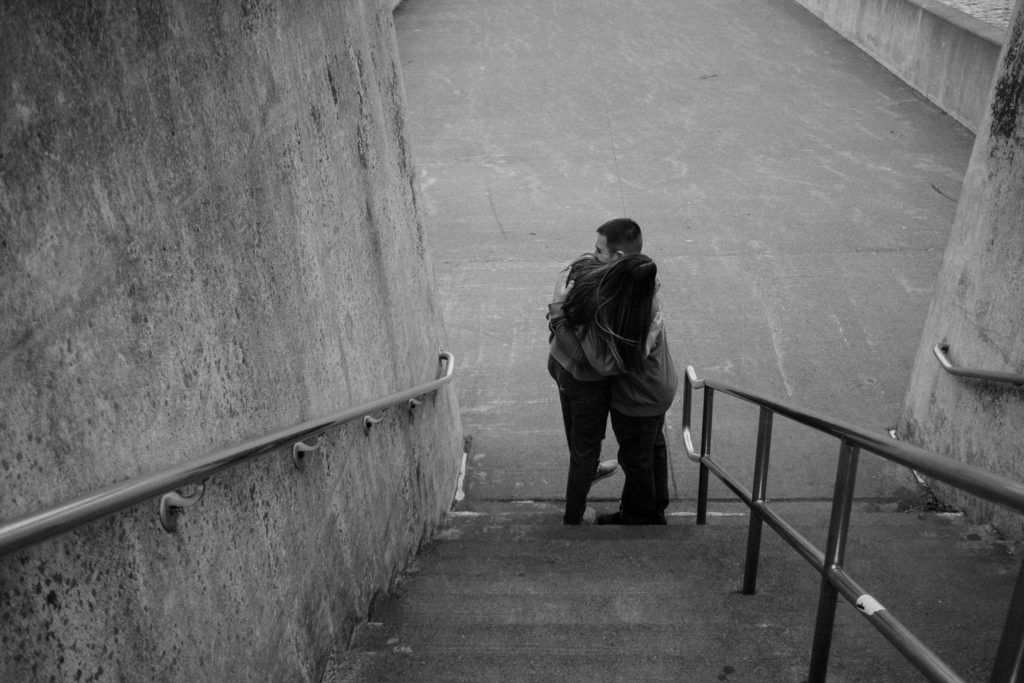 Couple embracing at the bottom of the stairs. Duluth 