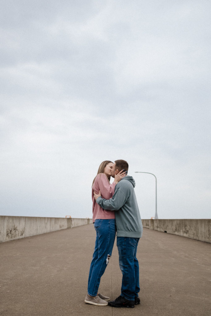 Couple kissing on a cloudy day in Canal Park Duluth MN