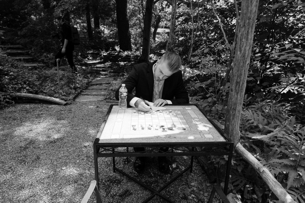 Groom writing his vows in a quiet outdoor nook at The Lantern Court Estate at Holden Arboretum in Cleveland Ohio.