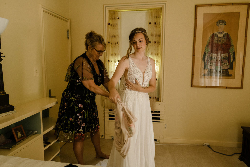 Bride getting dressed and sharing a first look with her family and friends before the wedding at the Lantern Court Estate at Holden Arboretum in Cleveland Ohio.