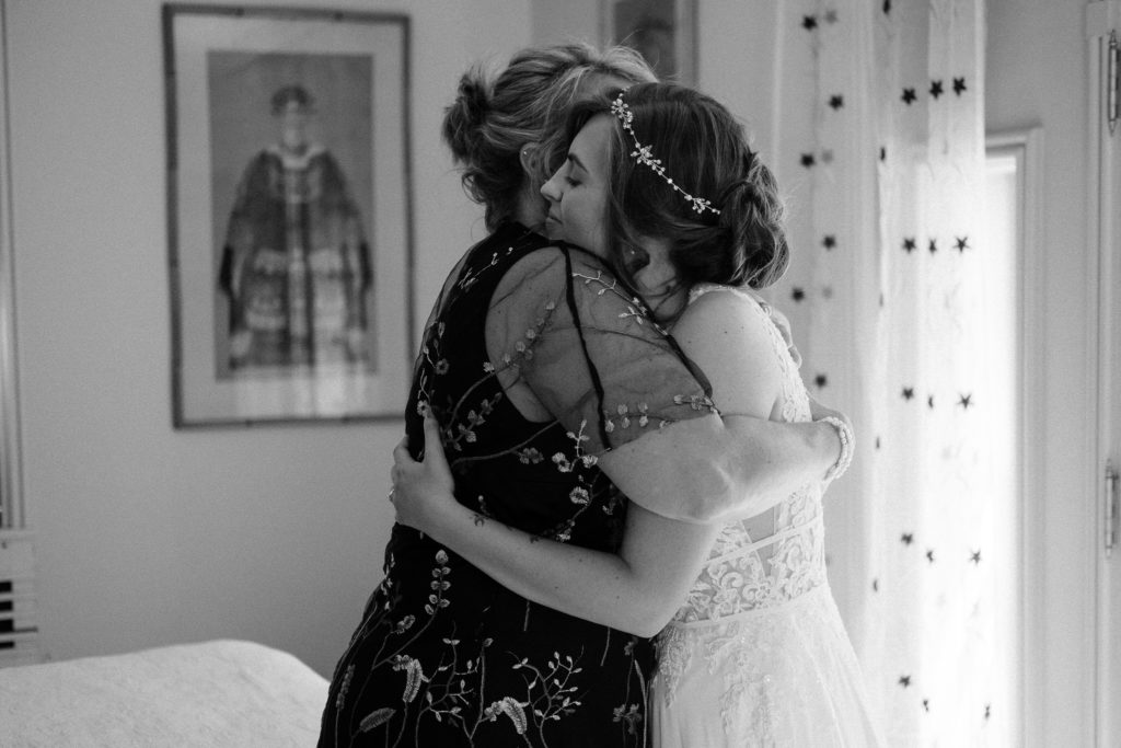 Bride and her mom hugging after getting dressed. The Lantern Court Estate at Holden Arboretum in Cleveland Ohio.