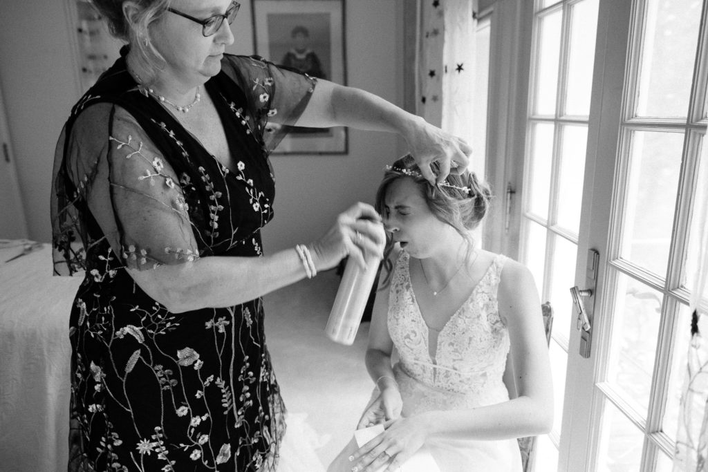 Bride getting dressed and sharing a first look with her family and friends before the wedding at the Lantern Court Estate at Holden Arboretum in Cleveland Ohio.