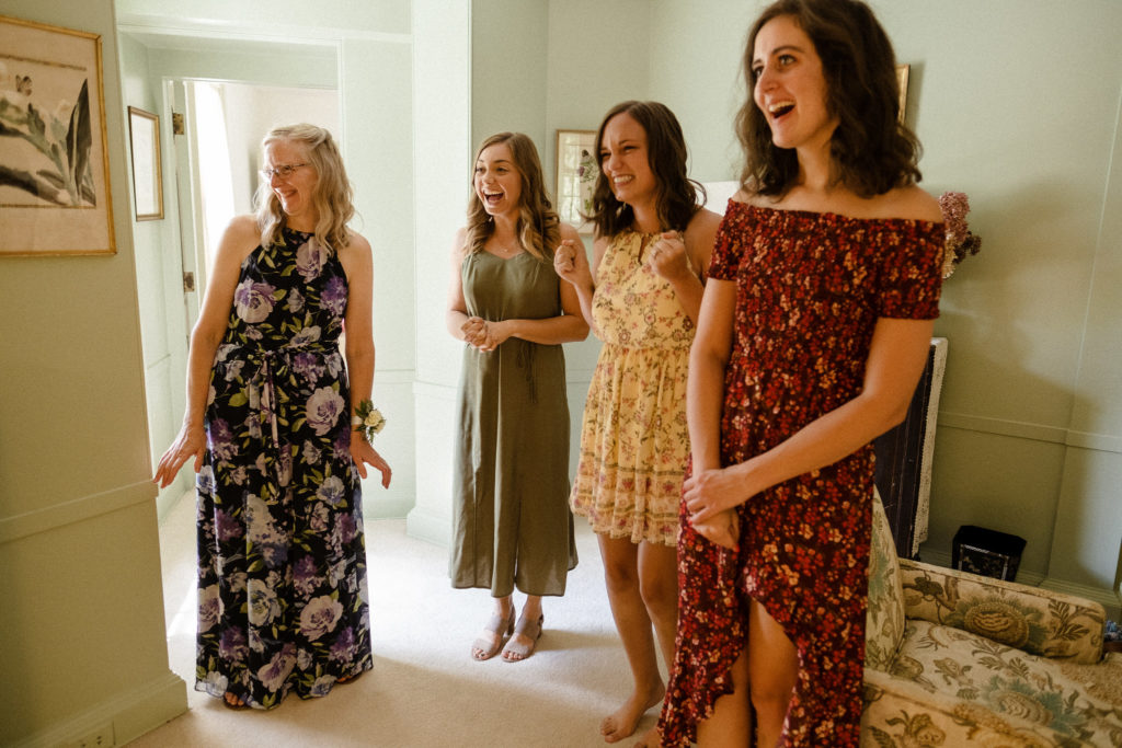 Bride sharing a first look with her bridesmaids before the wedding at the Lantern Court Estate at Holden Arboretum in Cleveland Ohio.