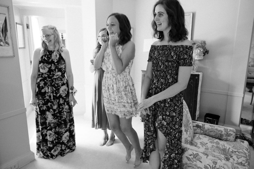 Bride sharing a first look with her bridesmaids before the wedding at the Lantern Court Estate at Holden Arboretum in Cleveland Ohio.