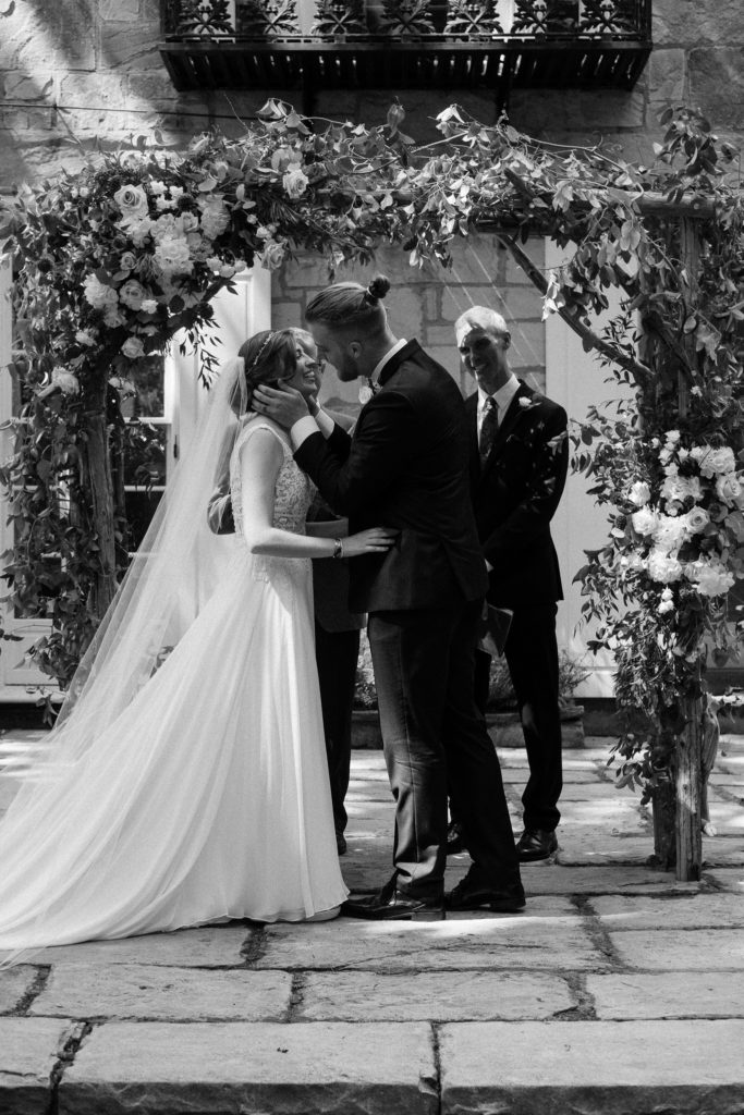 First kiss as husband and wife during their intimate weekday wedding at The  Lantern Court Estate at Holden Arboretum, Cleveland Ohio.