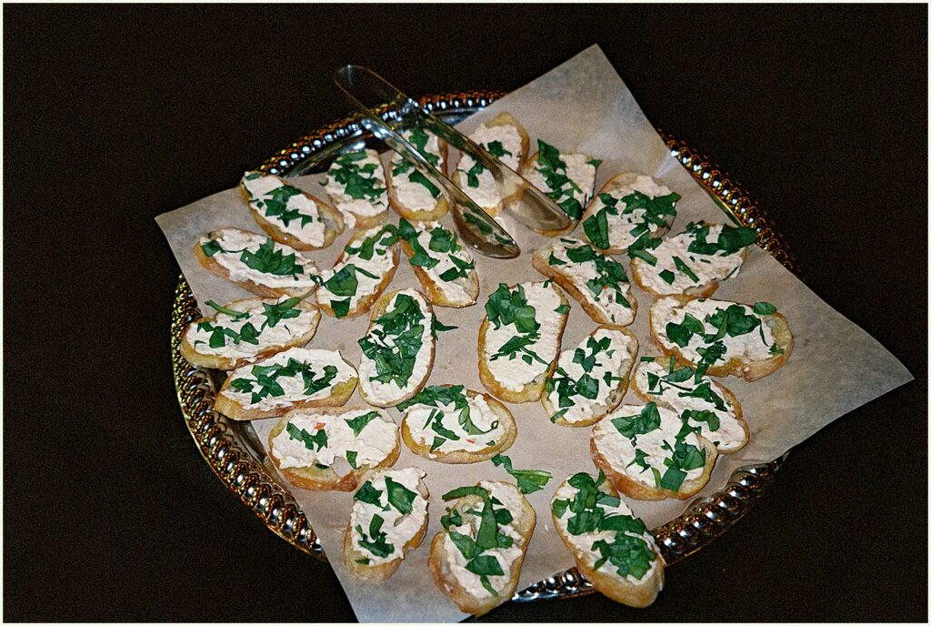 Crostinis sit on a tray at a cocktail hour.