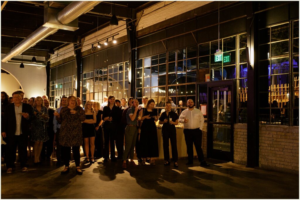 Wedding guests gather for a nighttime reception in a Minneapolis brewery.