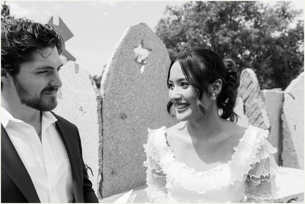 A bride laughs at a groom.