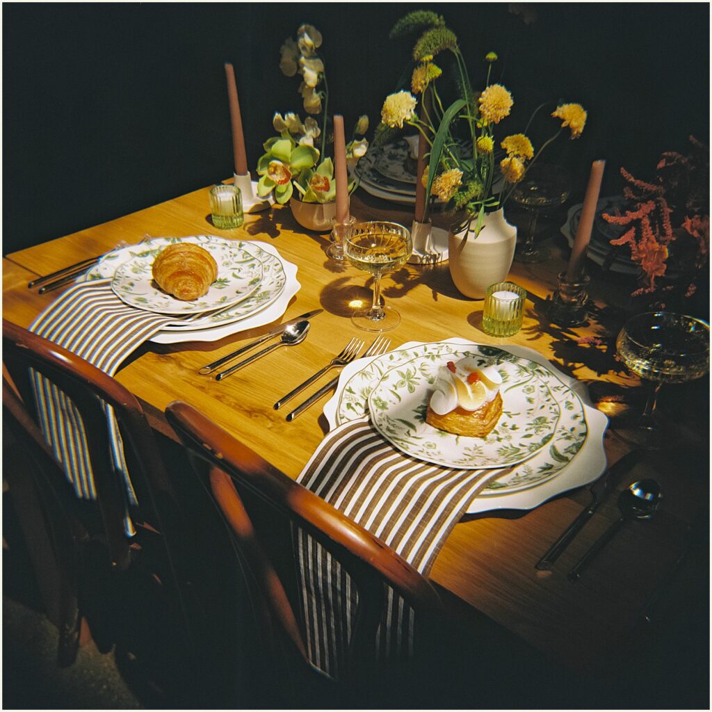 Pastries, flowers, and candles decorate a table for a wedding reception at Diane's Place.