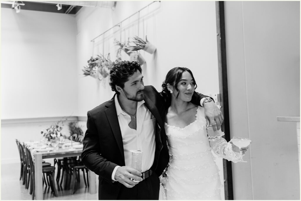 A bride and groom walk through at a doorway at a Minneapolis restaurant.