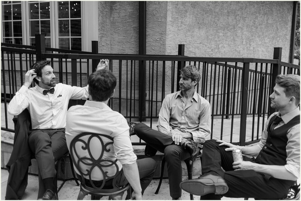 Guests sit talking in chairs in a courtyard.